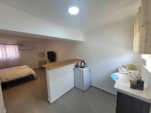 a small room with a bed and a small refrigerator at Sea of Galilee place in Tiberias +15 photos