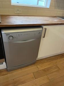 a kitchen with a dishwasher under a counter at Lovely room in Bristol 5 in Bristol +11 photos