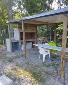 ein Picknicktisch und Stühle unter einem Schuppen in der Unterkunft La Chichi in Sauce de Portezuelo