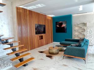a living room with a blue couch and a wooden wall at Villa Folie in Roquebrune-Cap-Martin