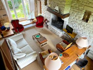 an overhead view of a living room with a stone fireplace at Cottage de Keran in Arradon