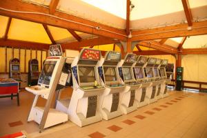 a row of video game machines in a room at Oasi Beach Hotel in Vieste