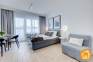 a living room with a couch and a table at Apartamenty Aquamarina Onyx - visitopl in Międzyzdroje