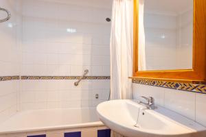 a bathroom with a sink and a bath tub at Apartamentos Solset Nerja in Nerja