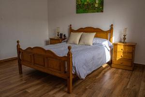 a bedroom with a wooden bed and two night stands at Live Adeje Ifonche Relax Place with Terrace in Adeje
