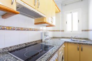 a kitchen with a sink and a counter top at Apartamentos Solset Nerja in Nerja