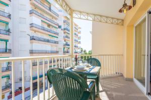 a balcony with a table and chairs and a building at Apartamentos Solset Nerja in Nerja