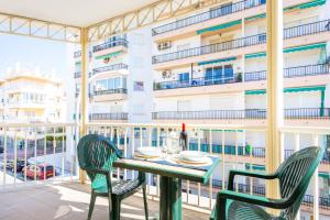 a table and chairs on a balcony with a view of a building at Apartamentos Solset Nerja in Nerja