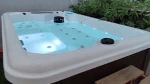 a white bath tub with a blue water at Madrid Centro, Edificio Entero Solo Para Ti in Madrid