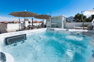 a hot tub on the roof of a house at The Grand Apartment Rovinj in Rovinj