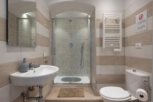 a bathroom with a sink and a shower and a toilet at Blu Sea Rooms in La Spezia