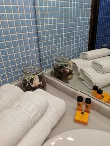 a bathroom with towels and a sink and a mirror at Casa Rural El Gidio in Parres de Llanes