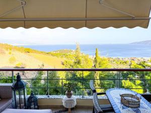 a view of the ocean from a balcony at Maison De Poupee in Loutra Oraias Elenis 