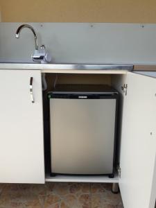 a dishwasher underneath a sink in a kitchen at Apartman" Ruža" in Višegrad