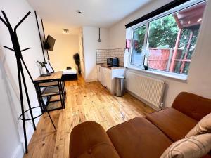 a living room with a couch and a large window at Flat 4, 10 St John's in Bournemouth