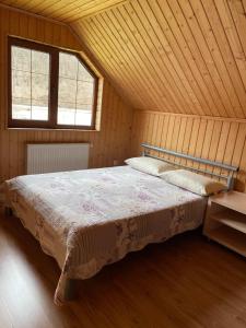 a bedroom with a bed in a wooden cabin at Kvasy 838 in Kvasy