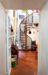 a hallway with a staircase and a stair case at LE STREGHE rooms e art con garage in Livorno