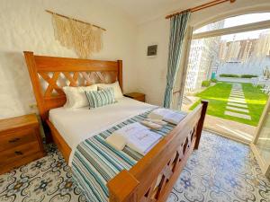 a bedroom with a bed and a large window at The Fountain Hotel in Cesme