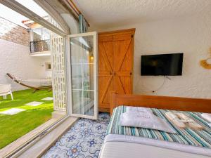 a bedroom with a bed and a sliding glass door at The Fountain Hotel in Cesme