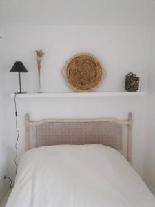 a bedroom with a white bed and a white wall at Tamarina in Guéthary