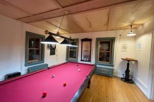 a pool table with balls on it in a room at ADK Game House in Au Sable Forks