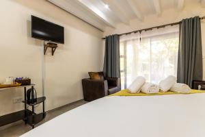 1 dormitorio con 1 cama grande y TV en la pared en Nyathi Lodge en Richards Bay