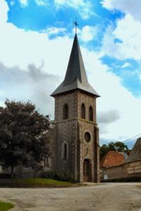 a church with a steeple with a cross on it at Maison de 2 chambres avec wifi a Avesnes en Val in Avesnes-en-Val