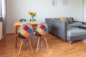 a living room with a table and a couch at Strawberry Apartment in Bratislava