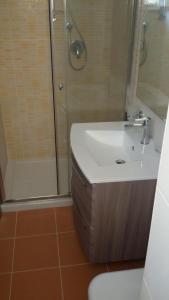 La salle de bains est pourvue d'un lavabo et d'une douche. dans l'établissement Appartamento Valle dei Templi, à Realmonte
