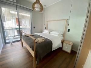 a bedroom with a bed and a large window at Athenian urban experience in Athens