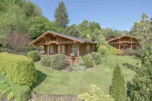 a log home with a yard and a fence at Beautiful 2 Bedroom Log Cabin With Private Hot Tub - Elm in Leominster
