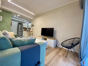 a living room with a couch and a flat screen tv at Athenian urban experience in Athens