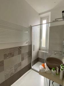 a bathroom with a glass shower and a sink at Affittacamere Flori in La Spezia
