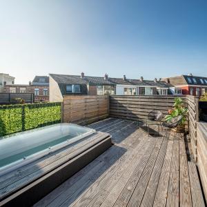 a swimming pool on the deck of a house at Luxury City Home Alkmaar nearby Amsterdam. in Alkmaar