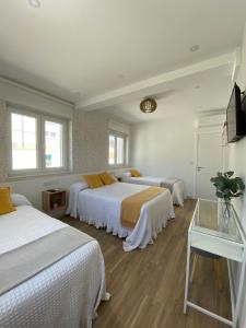 Ένα ή περισσότερα κρεβάτια σε δωμάτιο στο PortoSantiago Boutique & Rooms