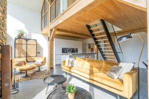 a living room with a couch and a staircase at Buytenplaats Villa 181 in De Koog