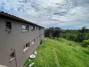 a building with a grass yard next to a building at Carod Espacio Serrano in Salsipuedes
