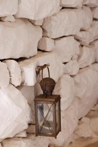 a lantern is hanging on a stone wall at Lithos Stone Suites in Areopolis