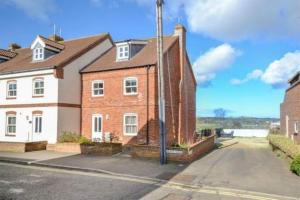 a large brick house on a city street at Bakers Yard in Wells next the Sea