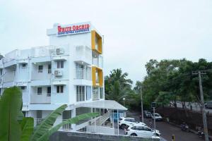 a white building with a sign that reads hotel opera at The White Orchid Luxury Service Apartments in Ernakulam