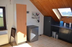 a kitchen with a refrigerator and a counter in a room at Gemütliche Dachgeschoßwohnung in Rheinbach