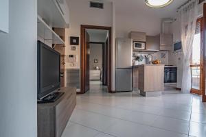 A kitchen or kitchenette at Cagliari Modern Apartment with Private Parking!