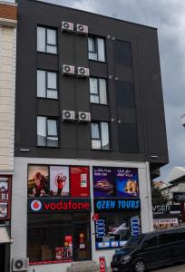 a black building with signs on the side of it at QZEN SUİT APART OTEL in Trabzon