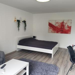 a bedroom with a bed and a couch and a table at Bonn/Königswinter ferienwohnung in Königswinter