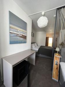 a bedroom with a bed and a chandelier at Hotel Abtshof in Halberstadt