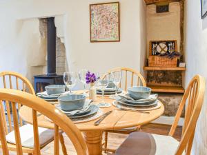 a dining room table with chairs and a wood stove at The Brew House in Tideswell