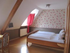 a bedroom with a bed in a attic at Weinhof Michael Morbach in Zeltingen-Rachtig
