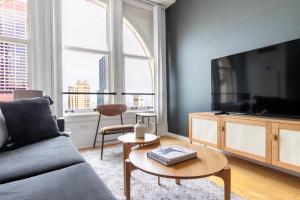 a living room with a couch and a tv at Loop 1BR w Gym Doorman nr L Parks CHI-303 in Chicago