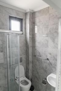 a bathroom with a toilet and a sink at QZEN SUİT APART OTEL in Trabzon