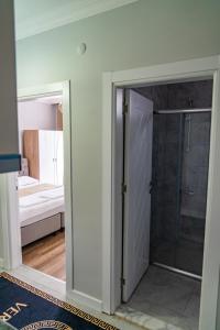 a glass door leading to a bathroom with a shower at QZEN SUİT APART OTEL in Trabzon